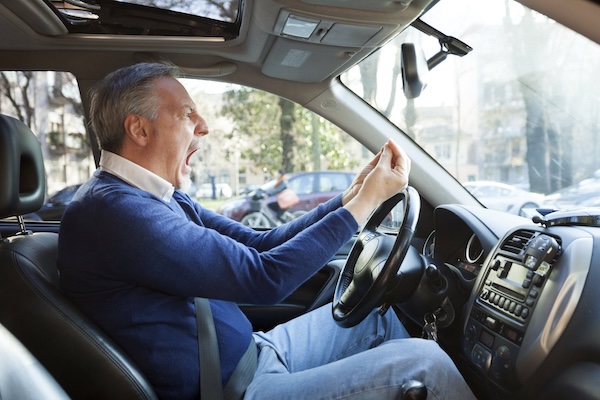 Angry man behind the wheel of a car